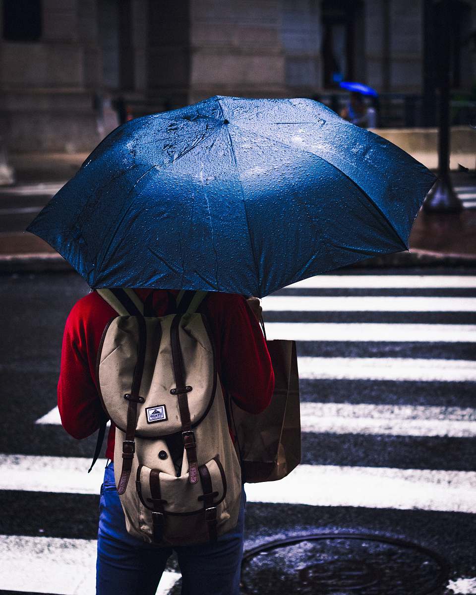 philadelphia person holding blue umbrella sad girl rain